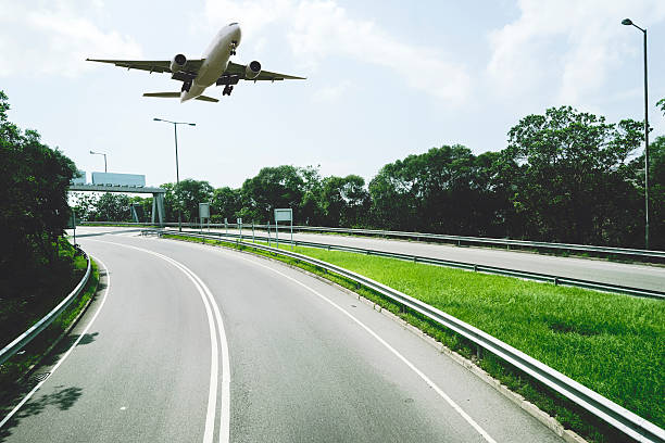 istock Urban road with airplane 512034452