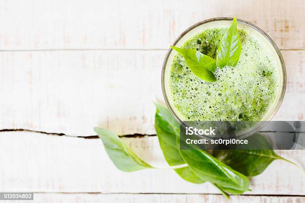Green Herbal Detox Drink Made Of Spinach On White Wood Stock Photo - Download Image Now