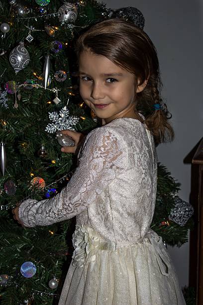 istock Smiling little girl near Christmas tree 512035480