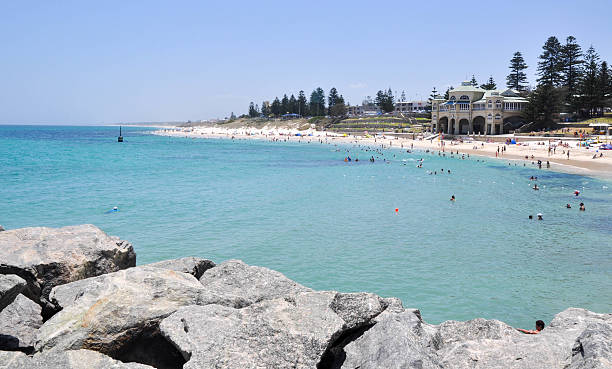Indian Ocean Seascape at Cottesloe Beach Cottesloe,WA,Australia-January 6,2016: Indian Ocean seascape at Cottesloe Beach with people and the Indiana Tea House along the coast line in Cottesloe, Western Australia. cottesloe beach stock pictures, royalty-free photos & images