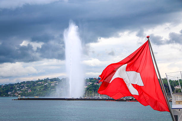 Switzerland flag and Jet d'Eau fountain at lake Geneva, Switzerland stock photo