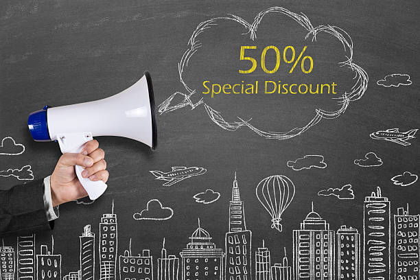 istock Hand holding megaphone with 50% Special Discount on cityscape background 512039588