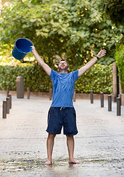 istock man pouring ice bucket on internet viral media campaign 512040369