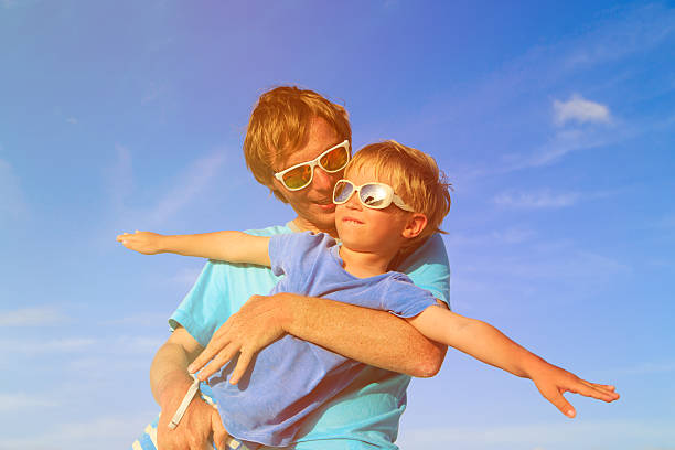 istock Father and little son playing on summer sky 512041274