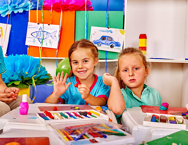 istock Group kids mold from plasticine  in kindergarten 512041614
