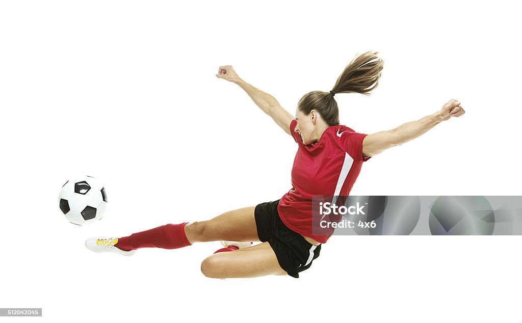 Female soccer player kicking the ball Female soccer player kicking the ballhttp://www.twodozendesign.info/i/1.png 20-29 Years Stock Photo