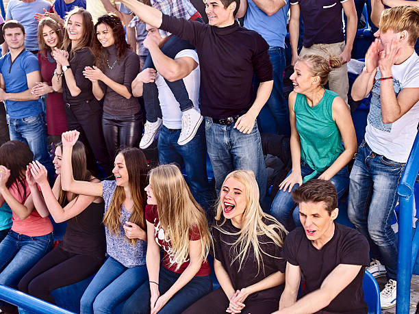 istock Sport fans clapping and singing on tribunes 512042164