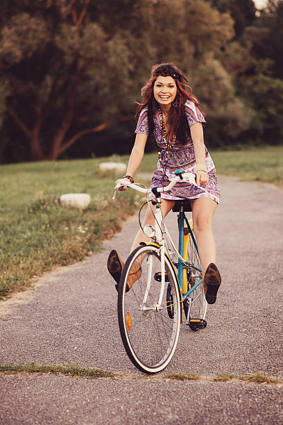 istock Young woman with bicycle in a park 512042399