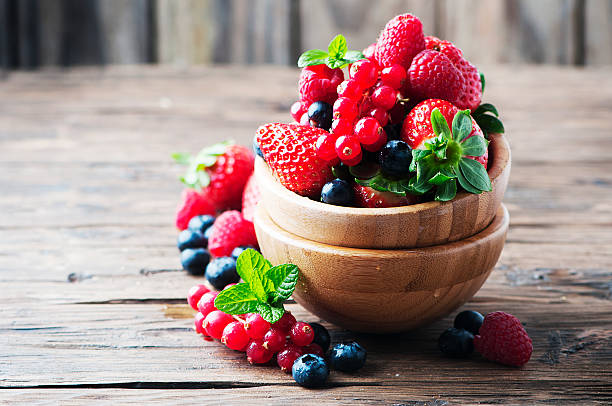 istock Mix of berry on the wooden table 512043282
