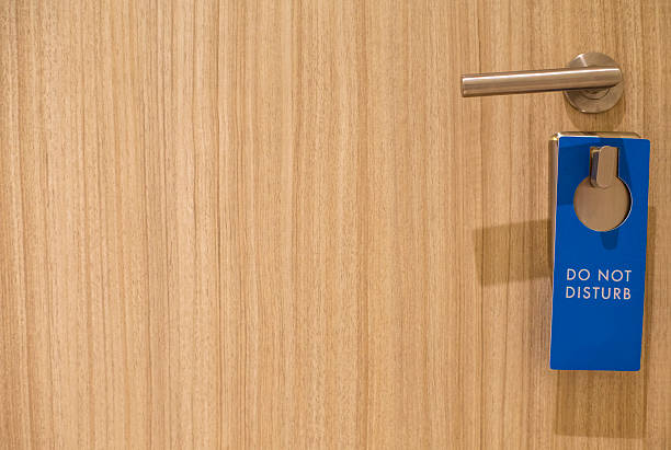 istock 'do not disturb' tag hanging on the door knob 512043446
