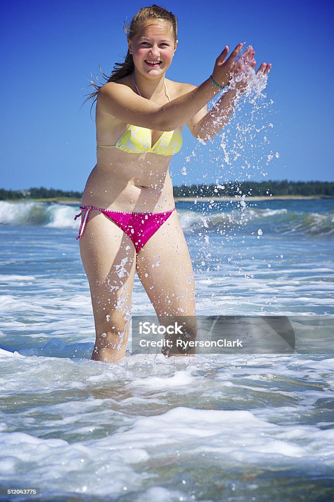 Teenage Girl at the Beach Splashing in Nova Scotia Teenage Girl at the Beach Splashing in Nova Scotia, Canada. 16-17 Years Stock Photo