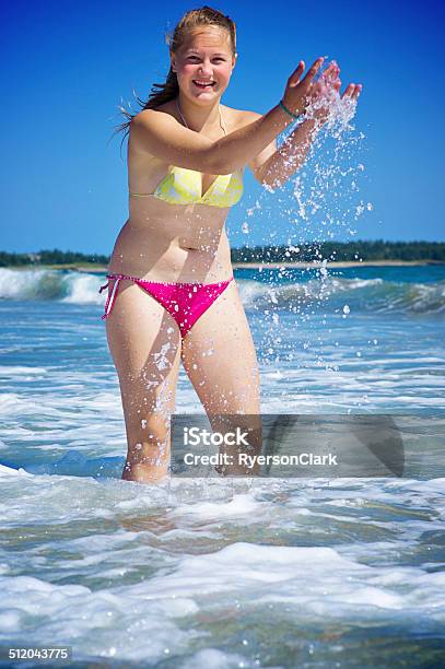 Teenage Girl At The Beach Splashing In Nova Scotia Stock Photo - Download Image Now - 16-17 Years, Adult, Adults Only
