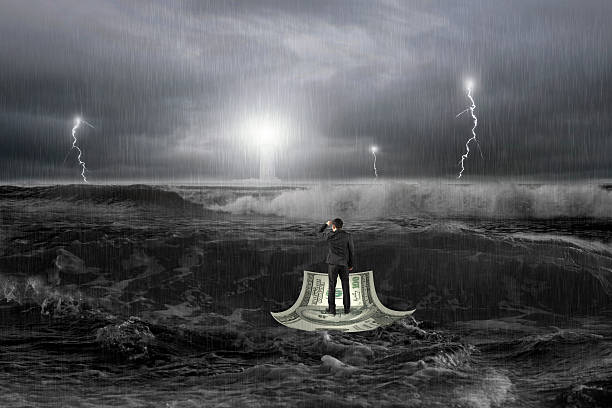 istock Man gazing lighthouse on money boat in ocean with storm 512043798