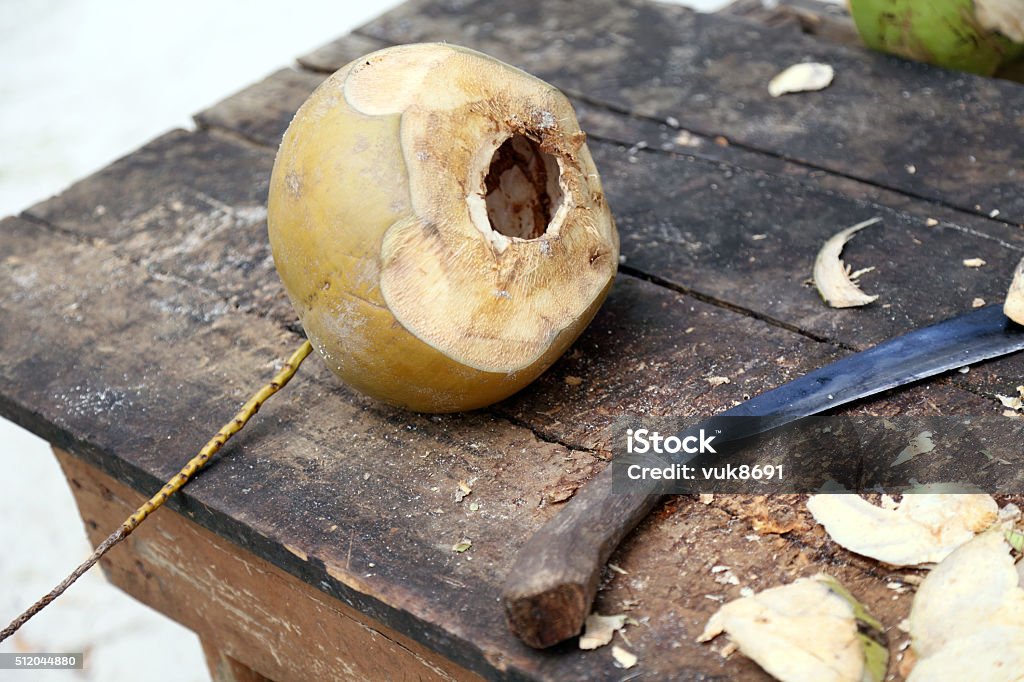 Table with coconut and a knife for cutting Asia Stock Photo