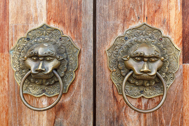 istock Old metal ornamental brass door handle close-up. 512044882