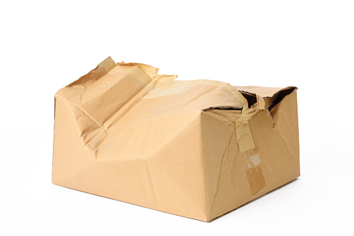 Crushed cardboard box isolated on white background with clipping path.