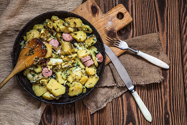istock fried potatoes with egg, herbs, sausages, pan, napkin, fork 512045546