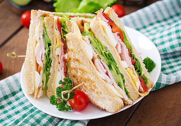 istock Club sandwich with cheese, cucumber, tomato, ham and eggs. 512045782