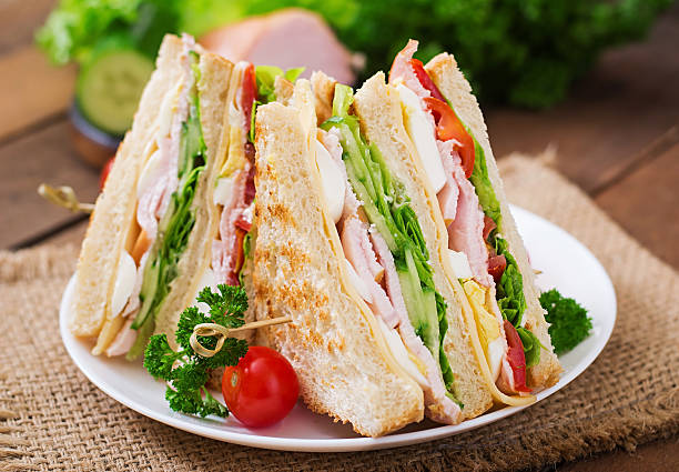istock Club sandwich with cheese, cucumber, tomato, ham and eggs. 512045830
