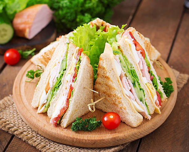 istock Club sandwich with cheese, cucumber, tomato, ham and eggs. 512046092
