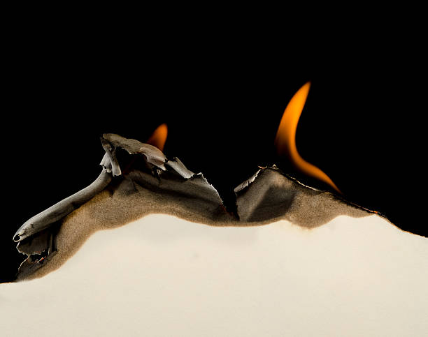 Burning edge of paper Curved edge of paper burnt and curled on a black background burnt stock pictures, royalty-free photos & images