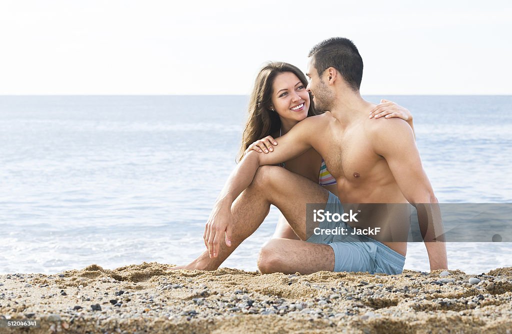 couple resting on the beach Happy young couple resting on the beach in summer 20-29 Years Stock Photo