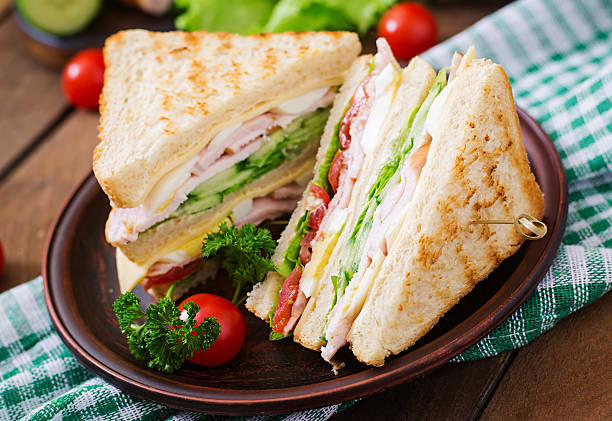 istock Club sandwich with cheese, cucumber, tomato, ham and eggs. 512046430