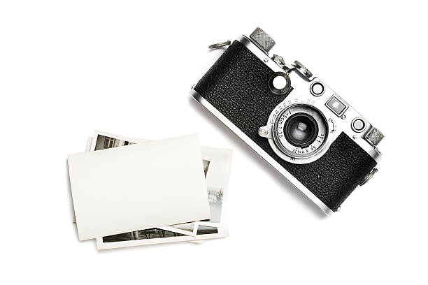 Vintage camera and old photos. View from the above. A classic 35 mm camera from 1939 with a blank photo. Put your own photo on the blank paper. strap photos stock pictures, royalty-free photos & images