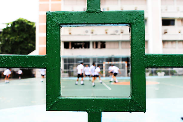 Kids playing soccer at schoolyard