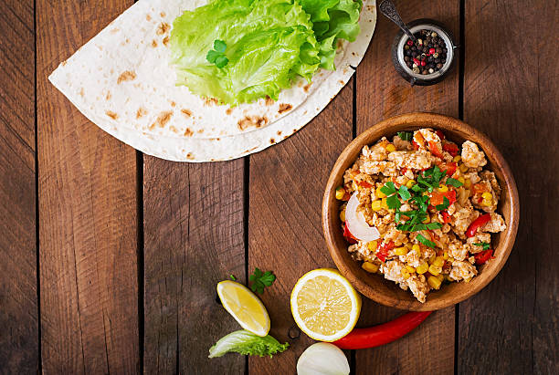 istock Ingredients for Burritos wraps chicken meat, corn, tomatoes 512048586