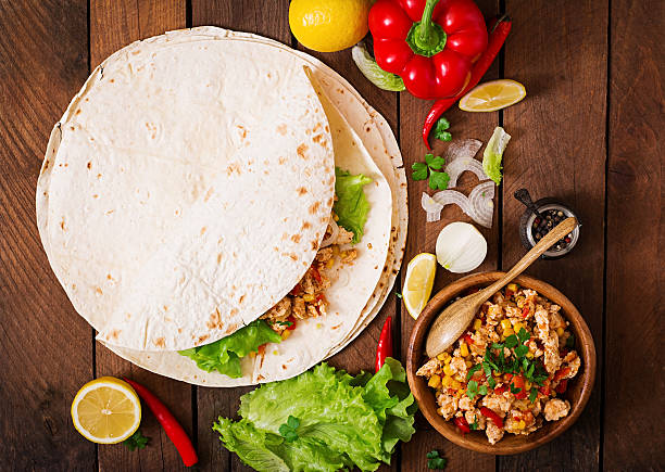 istock Ingredients for Burritos wraps chicken meat, corn, tomatoes 512048680