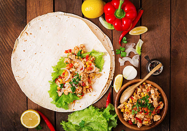 istock Ingredients for Burritos wraps chicken meat, corn, tomatoes 512048782