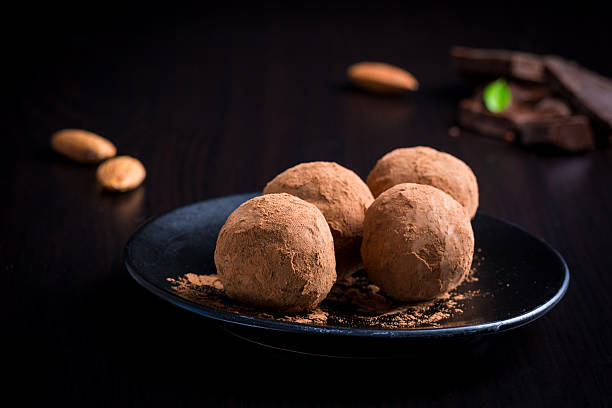istock Luxury chocolate truffles on black plate 512050518