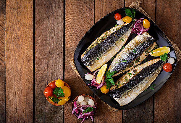 istock Baked mackerel with herbs and garnished with lemon 512050586