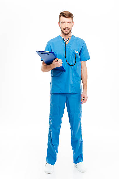 istock Happy male doctor standing with clipboard 512051396