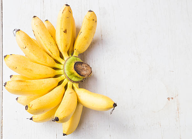 istock Yellow banana group on wooden background 512051822
