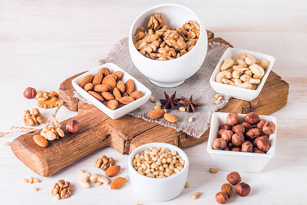 istock almonds, walnuts, hazelnuts cashews and pine nuts in wooden bowl 512052954