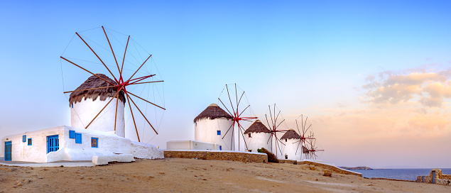 Panoramic view of traditional greek windmills on Mykonos island at sunrise, Cyclades, Greece