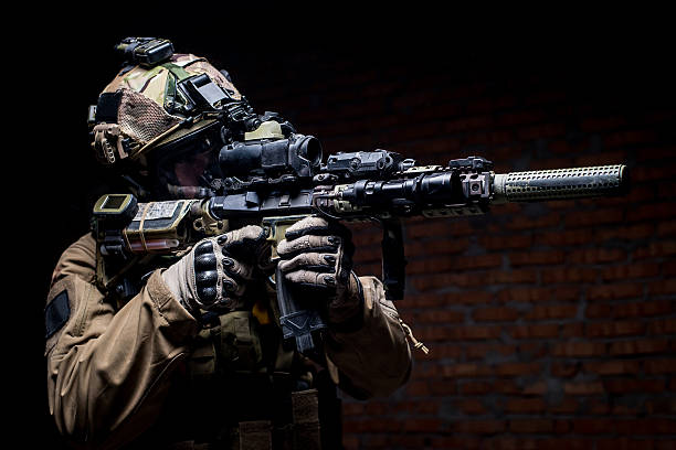 istock Spec ops soldier in uniform with assault rifle 512055204