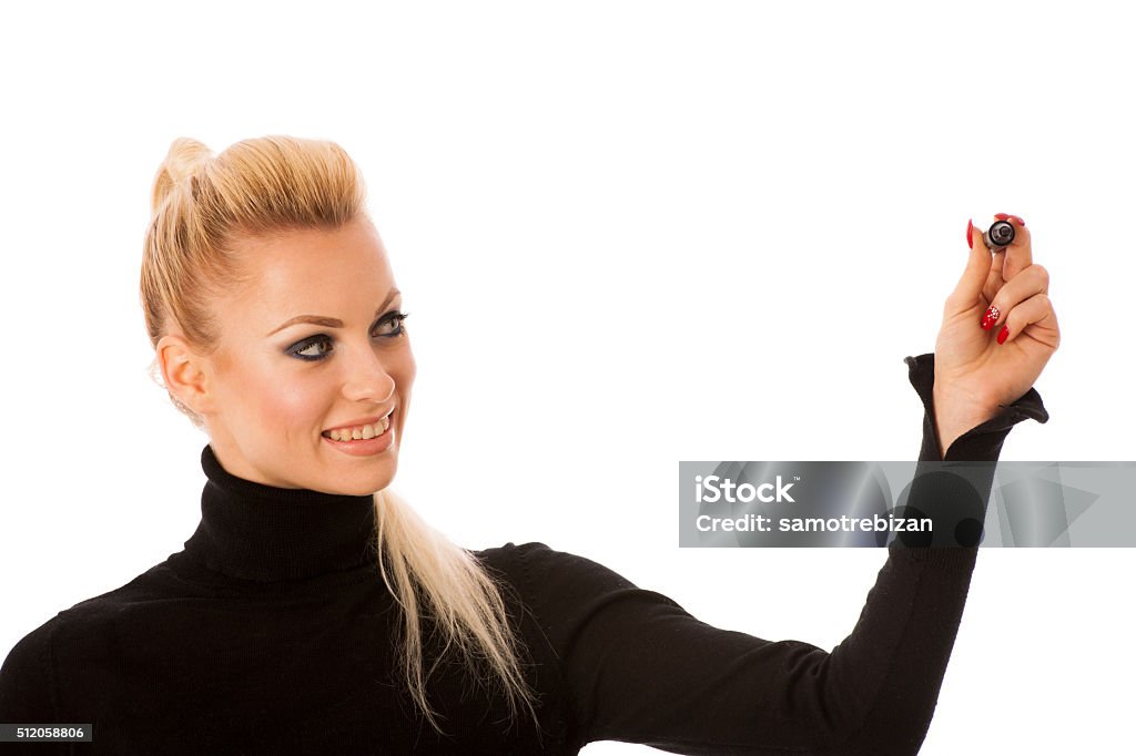 Woman writing encouraging success message with marker on transparent surface Young, blonde, happy woman writing encouraging success message with marker on transparent surface. Adult Stock Photo