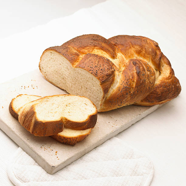 istock Freshly sliced white seed loaf on a cutting board. 512059718