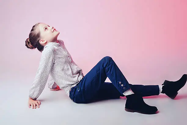 Photo of Portrait of a cute little  girl over pink background.