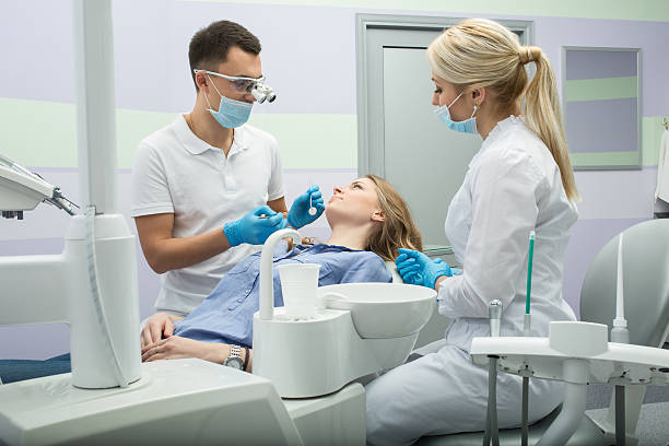 istock Dentist examining a patient's teeth in the dentist 512060680