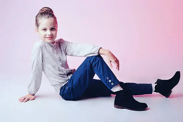 Photo of Portrait of a cute little girl over pink background.