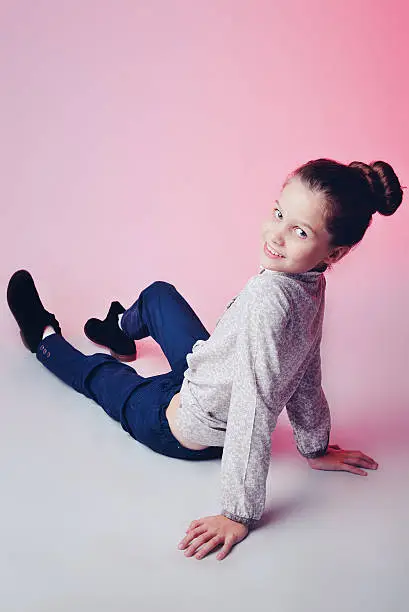 Photo of Portrait of a cute littlegirl over pink background.