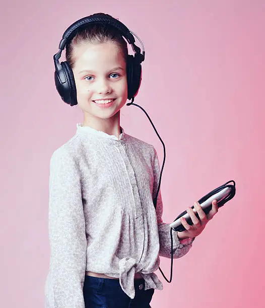 Photo of Portrait of a cute little girl over pink background.