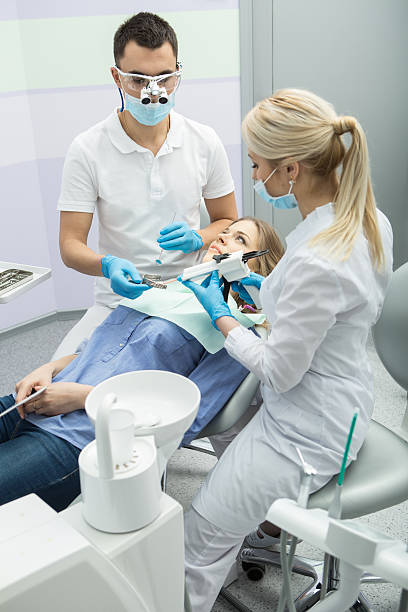 istock Dentist examining a patient's teeth in the dentist 512061402