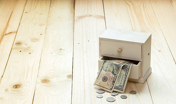 istock Money box on yellow wooden background 512062847
