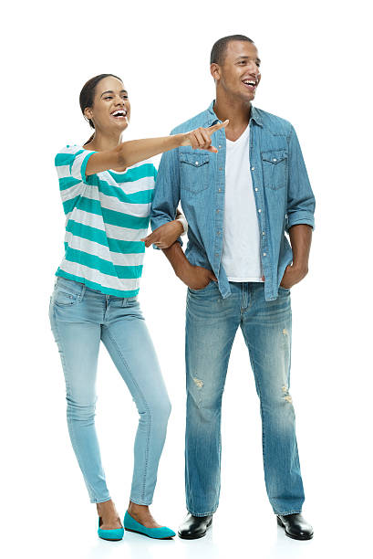 istock Casual couple standing together & pointing away 512081847