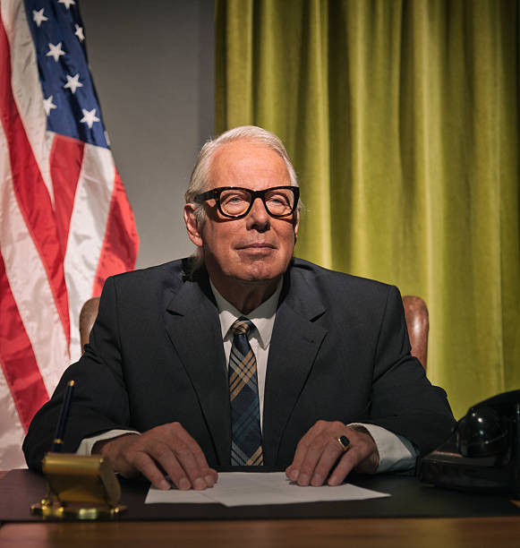 istock Big boss president wearing glasses sitting behind desk. 512082233